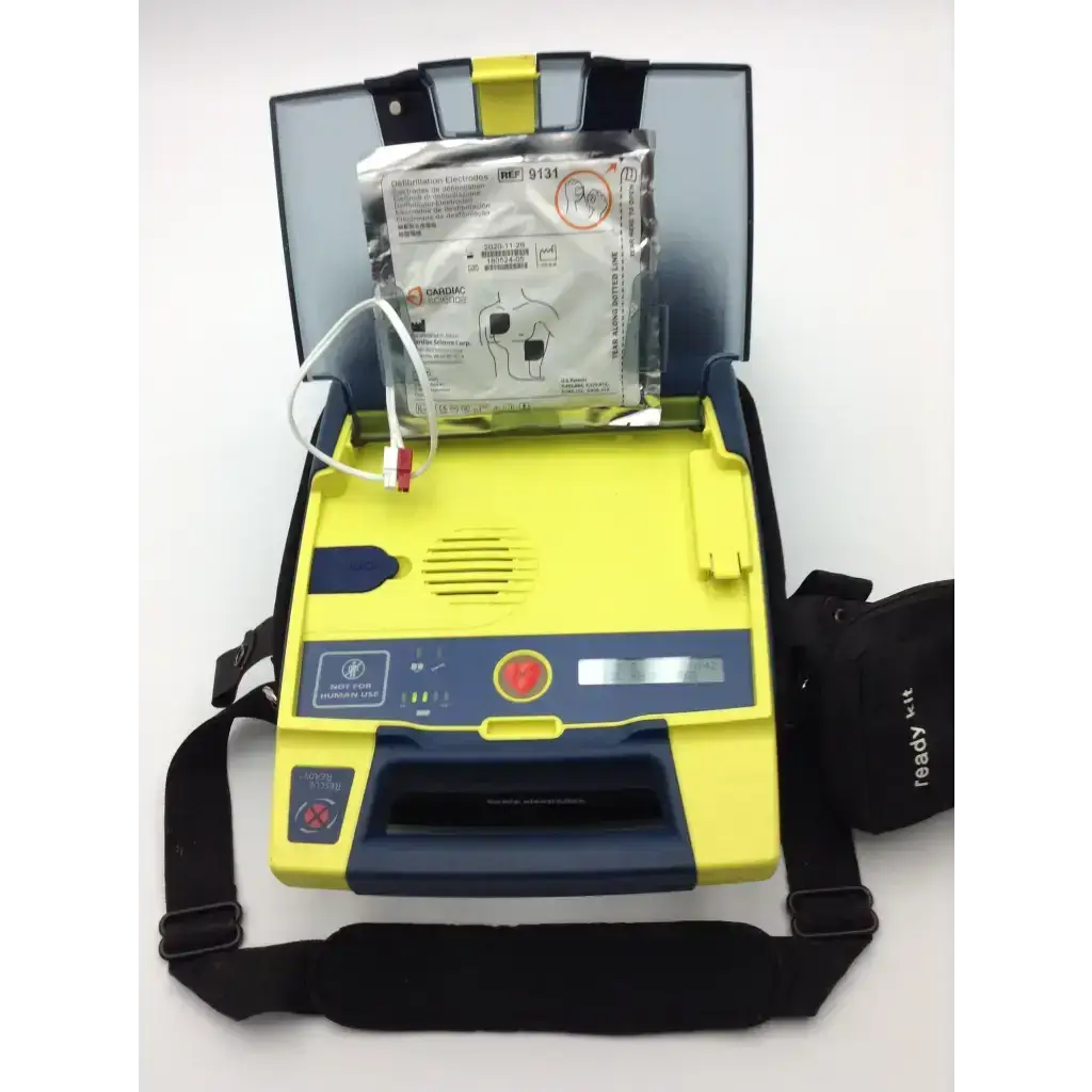 Yellow and blue cardiac science aed trainer with black carrying strap for training use with pads and case
