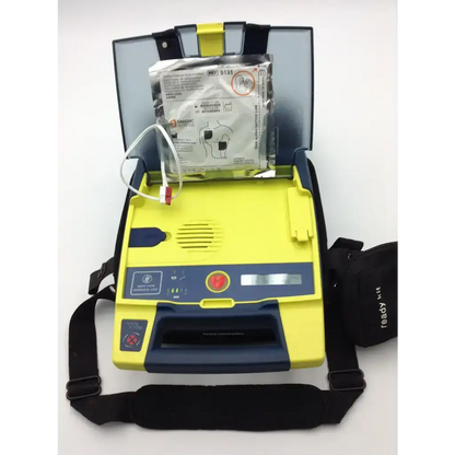 Yellow and blue cardiac science aed trainer with black carrying strap for training use with pads and case