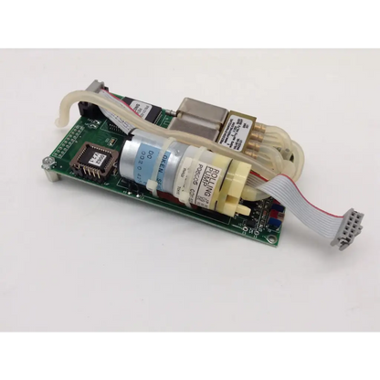 Beige and silver rolling pump mounted on green circuit board with tubing for cas medical systems 30-01-0041 rev 01