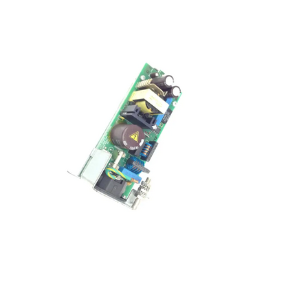 Green circuit board with black capacitors and yellow warning label on celestica m3046-60002 power supply unit