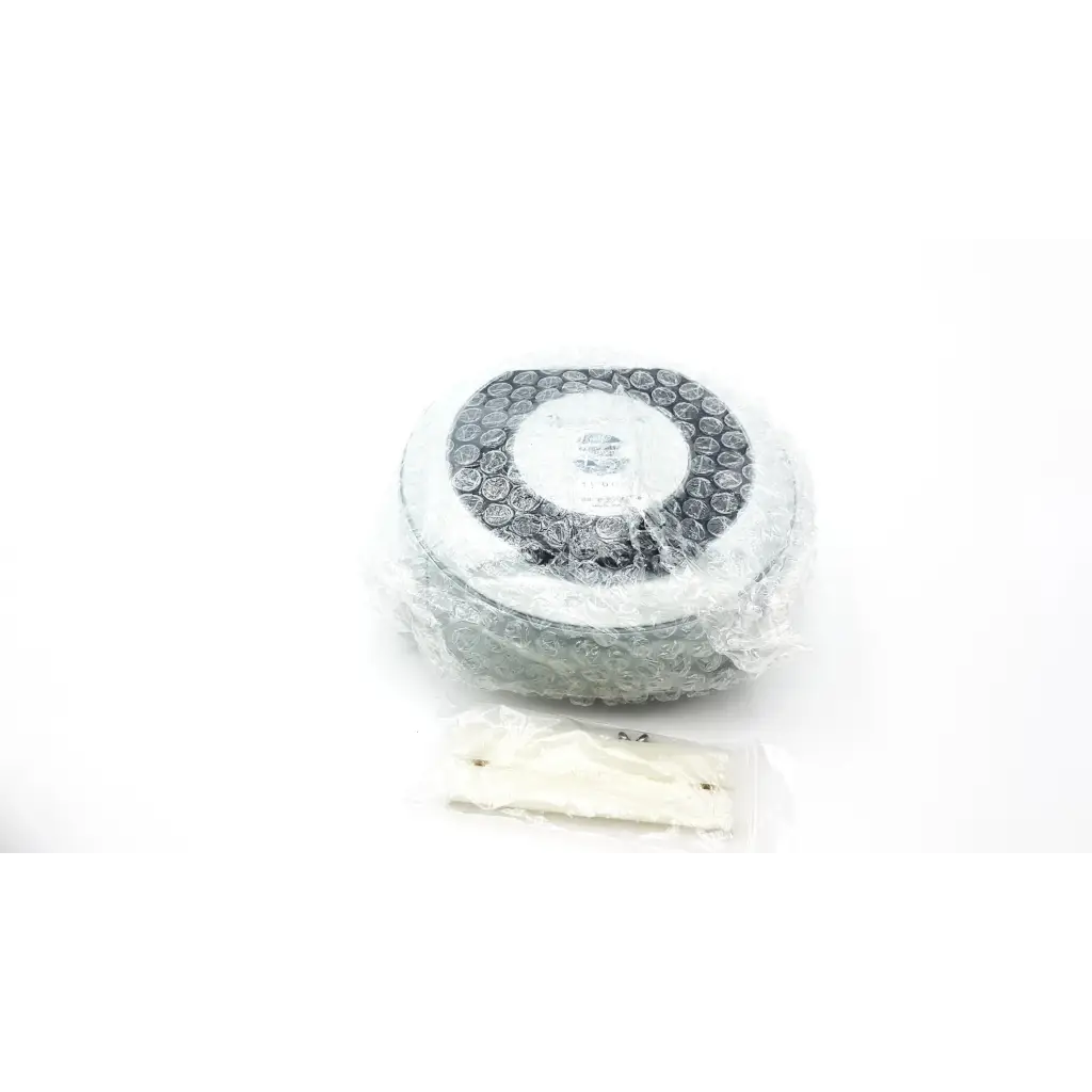 Silver circular air filter with white disc and black mesh wrapped in bubble wrap for centrak mm itdk-318 monitor ab3-6