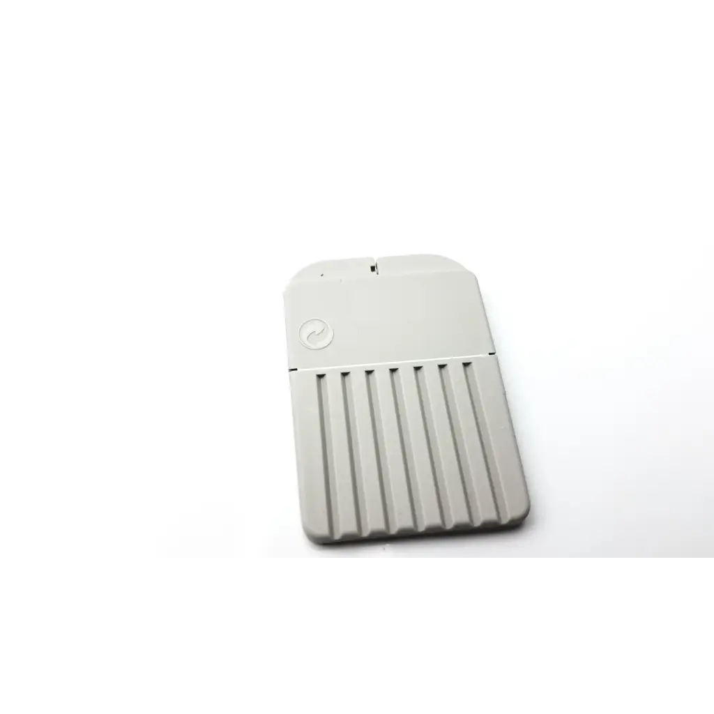 Gray rectangular portable hard drive with vertical ridges and circular logo for cerustop wax guards storage