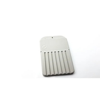 Gray rectangular portable hard drive with vertical ridges and circular logo for cerustop wax guards storage