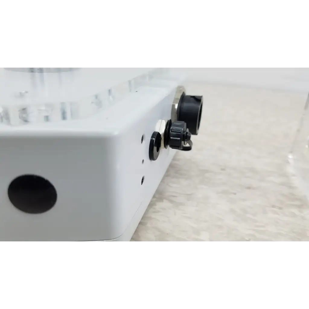 White rectangular chemdaq steri-trac 2 fixed gas monitor with black circular ports and knobs for safety detection