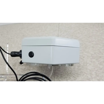 White rectangular ChemDAQ steri-trac 2 peracetic acid monitor with black circular port acrylic stand and cable