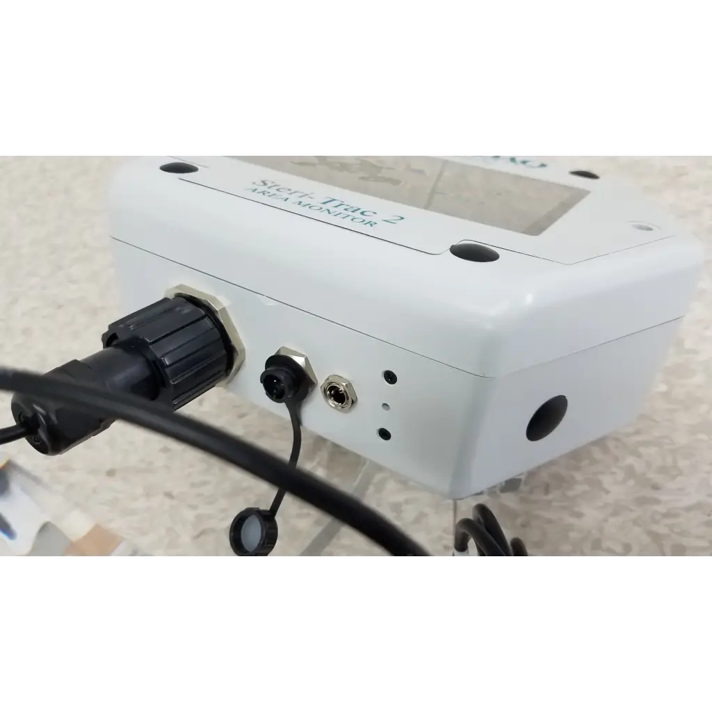 White rectangular stryker trac 2 vesa peracetic acid monitor with black ports on acrylic stand and cable