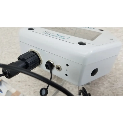 White rectangular stryker trac 2 vesa peracetic acid monitor with black ports on acrylic stand and cable