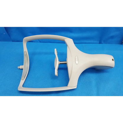 White plastic dental handpiece with curved handle and metallic shaft part of chin rest assembly for topcon trc-nw8 retinal camera