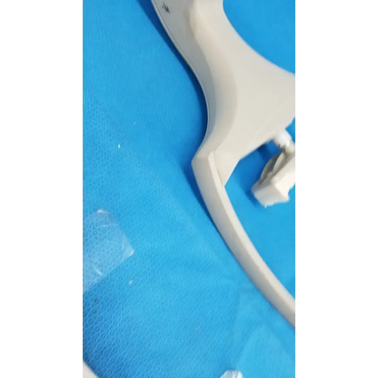 Off-white plastic medical speculum with ergonomic handle for chin rest forehead use with trc-nw6s chinrest paper