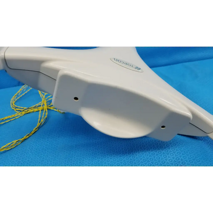 White plastic topcon surgical retractor with yellow sutures near chinrest forehead rest assembly for trc-nw6s camera