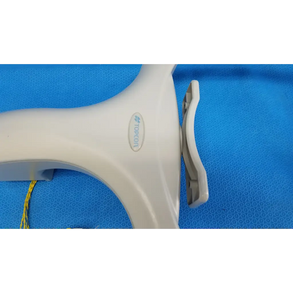 White plastic tormon handheld device with curved handle and gray clip for trc-nw6s chinrest forehead rest assembly