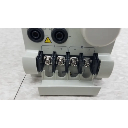 White plastic electrical terminal block with black insulated screws and silver connectors on chroma 63107 load module