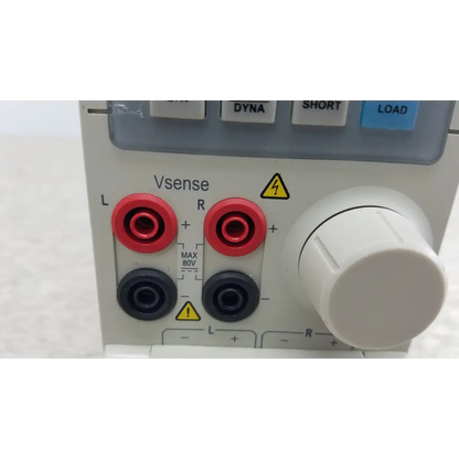 White lab power supply with red and black banana jacks l r large white voltage knob and safety warnings on chroma 63107 electronic load module