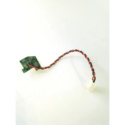 A green rev c board clb-0002 rev with a twisted red and black wire connected to a white connector for electronic use