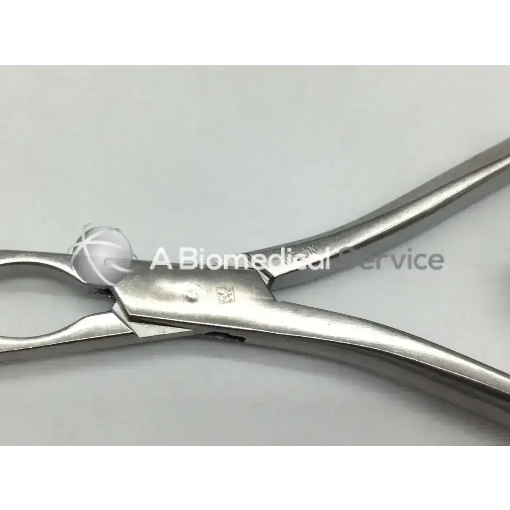 Stainless steel codman 2084r forceps with polished reflective surface and ergonomic handles for dental use