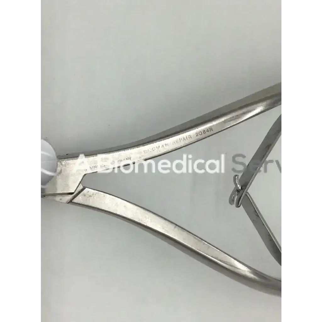 Stainless steel codman 2084r forceps with polished metallic finish and engraved handle markings for surgical use