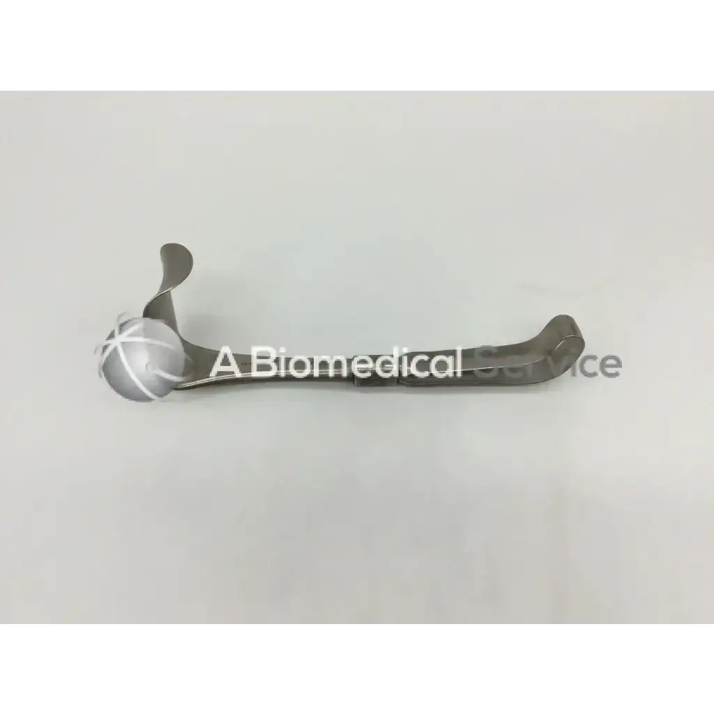 Silver-toned Codman 50-4112 surgical retractor with curved design and cross-hatched spherical handle for precision use