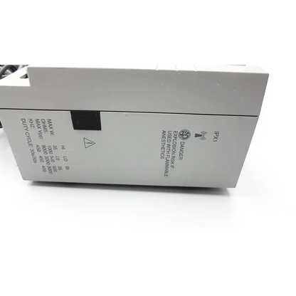 Gray industrial-grade conmed hyfrecator 2000 desiccator unit with black warning label and push pencil handpiece side view