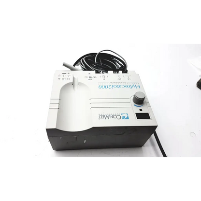 White and gray CONMED Hyfrecator 2000 esu high-frequency desiccator with coiled black power cord for dental use