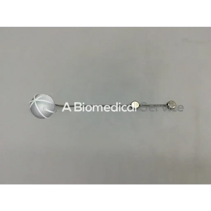 Silver spherical medical device with textured surface and metallic end caps on slender rod cook urological gyn surgical tool