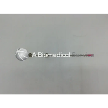 A sleek silver cook urological gyn surgical tool with a spherical white crosshatched head and metallic rod extension