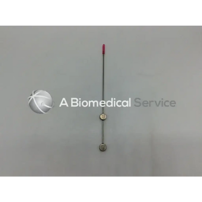 Slender metallic cook urological gyn surgical tool with pink tip and two circular weighted beads for ob/gyn use