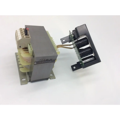 Gray metal power transformer 4av4110-2ab with beige terminal block and black capacitors mounted on circuit board