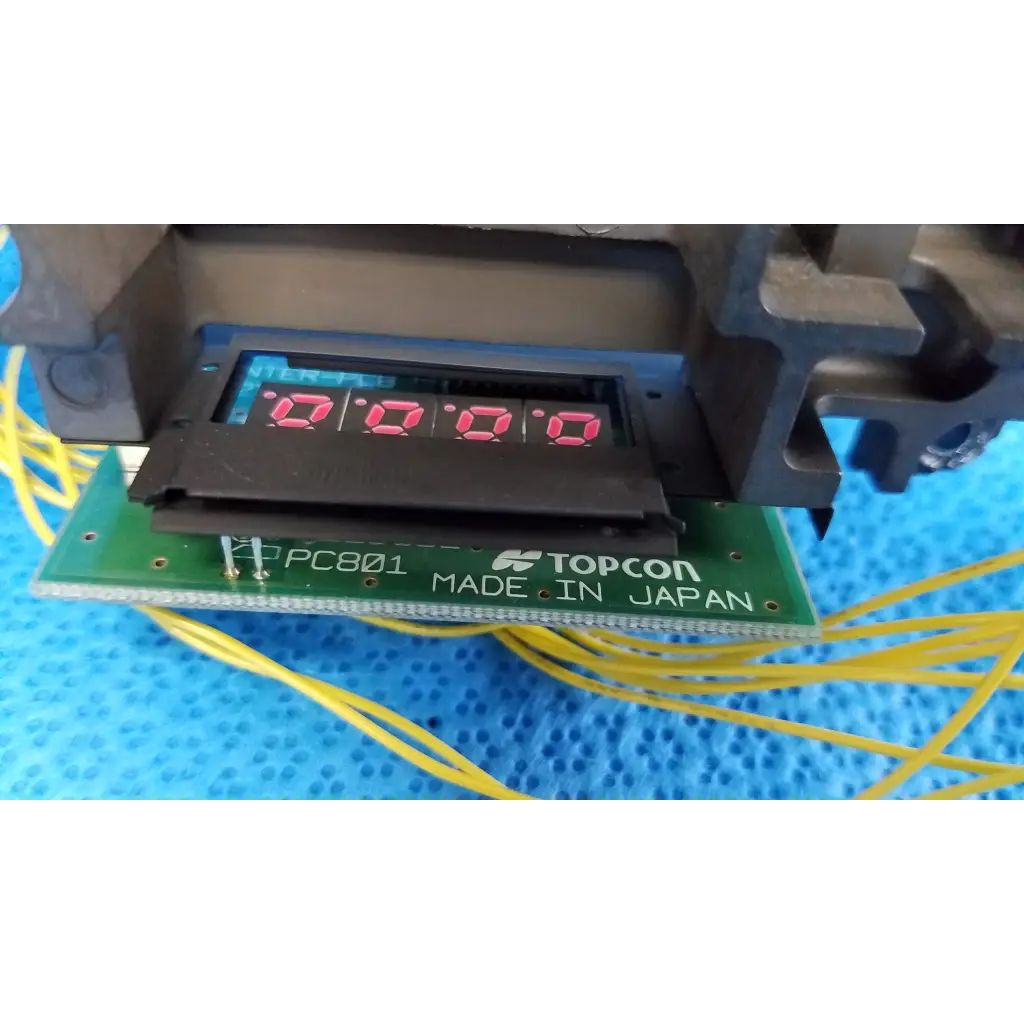 Black digital display with red numerals 0.0.0 on green circuit board for topcon retinal camera optical sensor housing