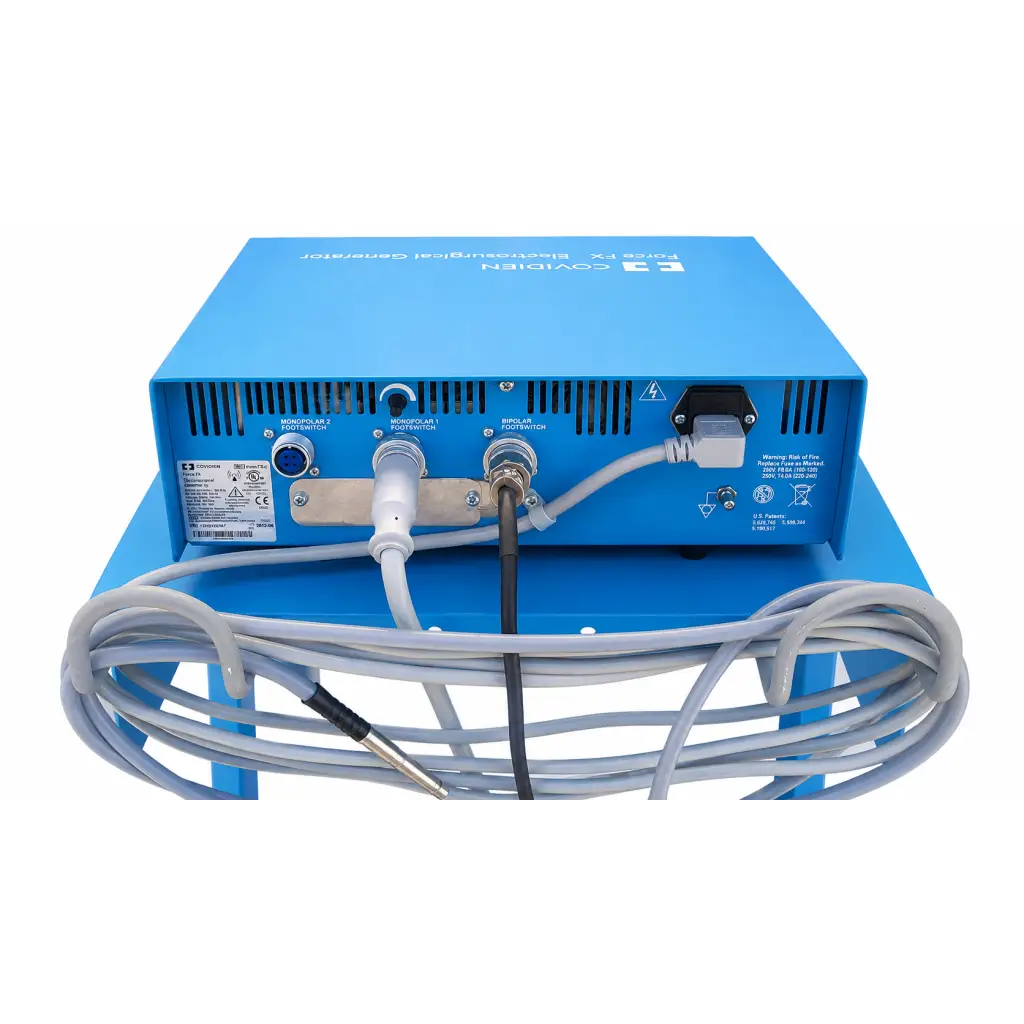 Back of blue covidien force fx-c electrosurgical generator with multiple ports and coiled gray cables on mobile cart