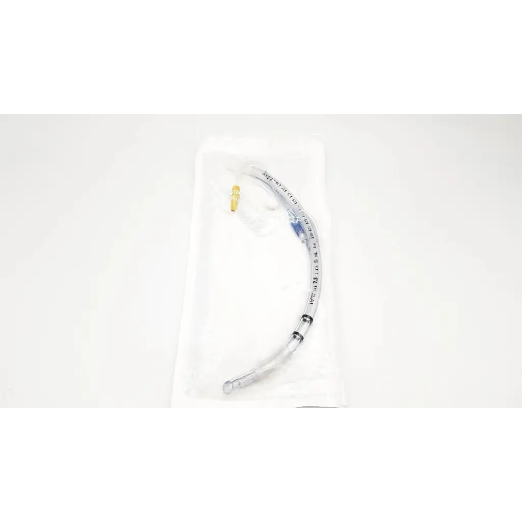 Clear plastic covidien shiley evac endotracheal tube with gold connector and blue markings in sterile white wrapping