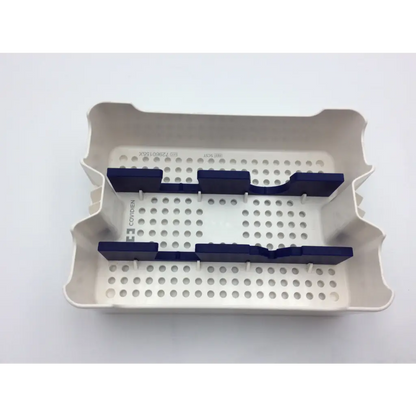 White plastic dental instrument tray with navy blue rubberized dividers in covidien surgical sonicision case