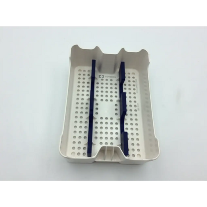 Beige plastic covidien surgical sonicision case tray with navy blue dividers and perforated surface for instrument storage