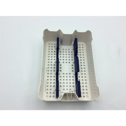Beige plastic dental instrument tray with dark blue dividers and perforated surface in covidien surgical sonicision case