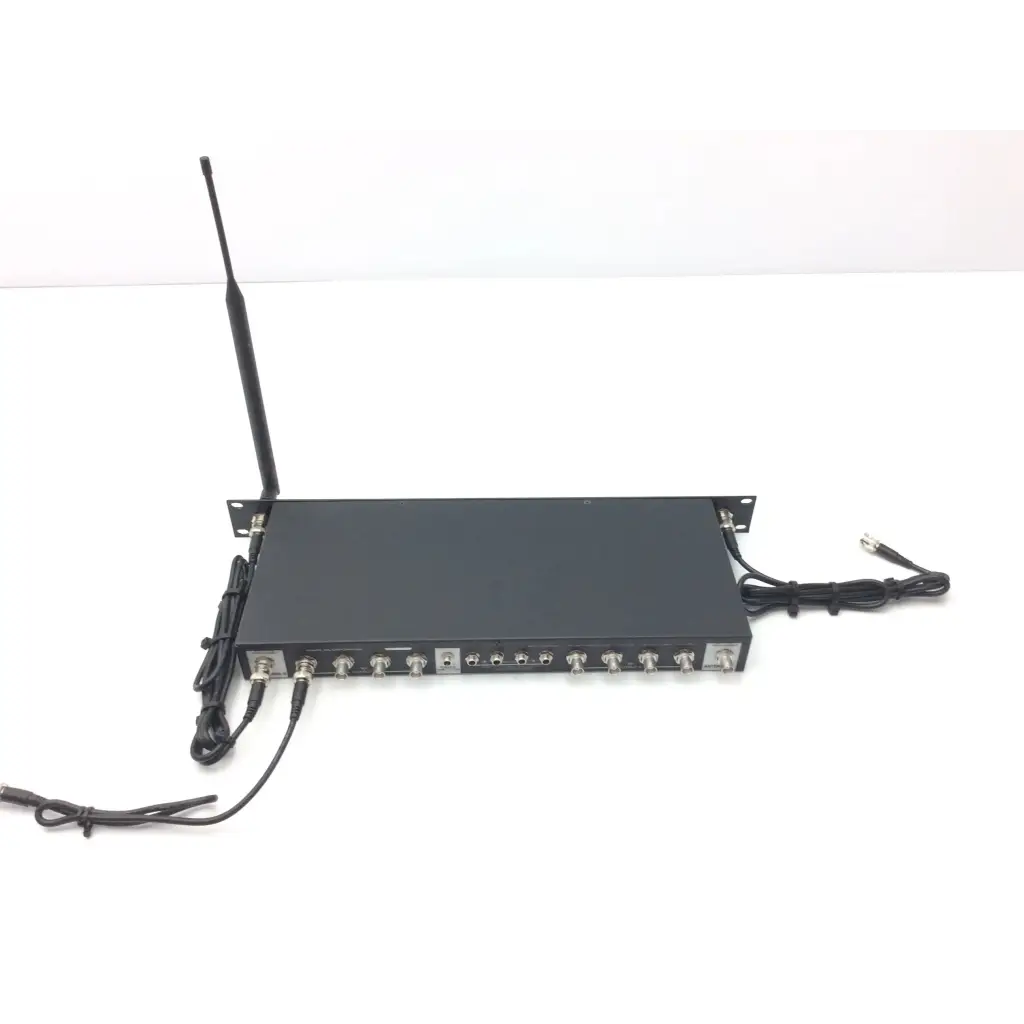 Black rectangular wireless microphone receiver with antenna and ports shown from back of crestron cp2e professional media system