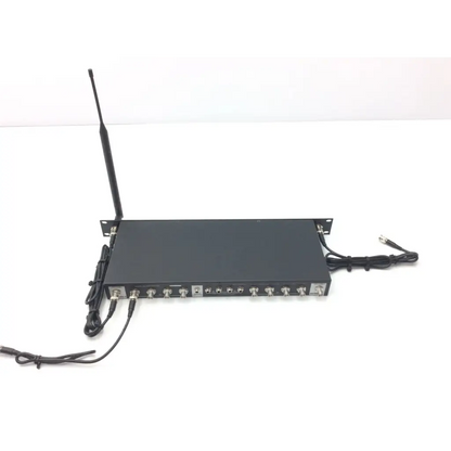 Black rectangular wireless microphone receiver with antenna and ports shown from back of crestron cp2e professional media system