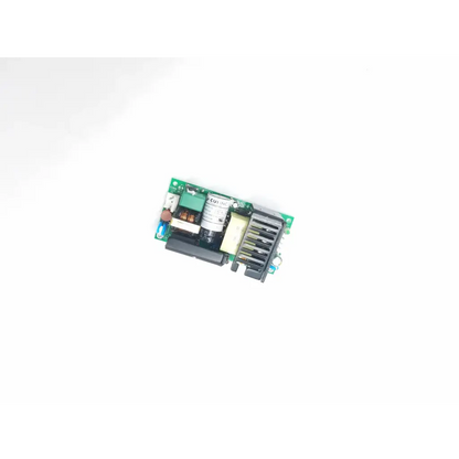 Green circuit board with black and beige components featuring white cylindrical capacitor labeled cui inc in series power supply
