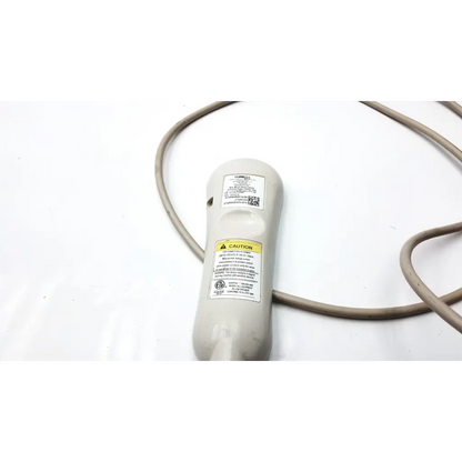 Gray plastic curbell speaker nurse call remote with coiled cable warning labels and certification stickers on back side
