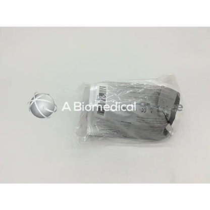 A gray sterile cysto-aid urine collection device v390 packaged in clear plastic with barcode and regulatory labels