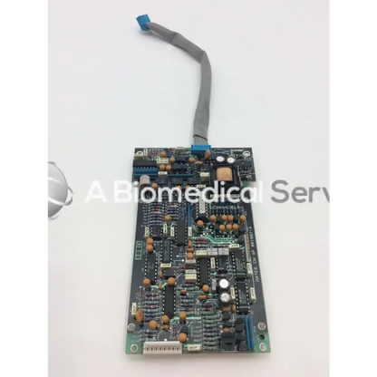 Datex CH 4F 881987-4 black circuit board bbce5-3 with gold capacitors and gray ribbon cable connected on top edge