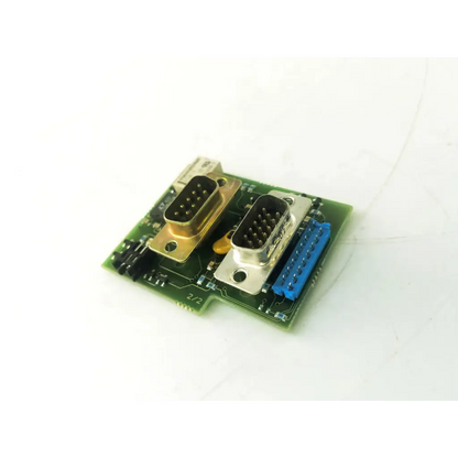 Green circuit board of datex- engstrom mc 4f 891512-3 with two metallic db9 connectors and a blue ribbon cable connector