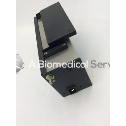 Black rectangular datex ohmeda electrical box risk class 2g with metallic interior and green circular label on the side