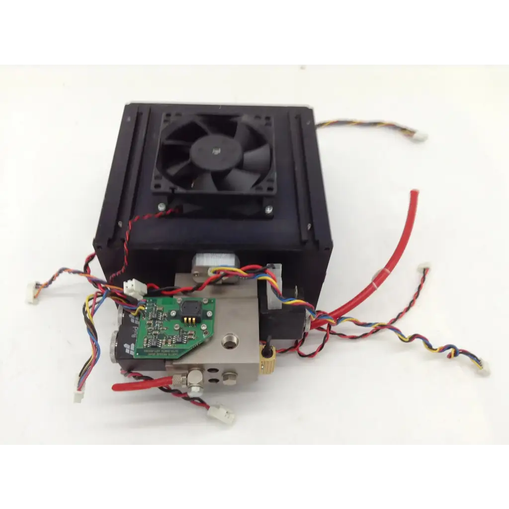 Black rectangular anesthesia machine part with integrated fan metallic components green circuit board and multicolored wiring
