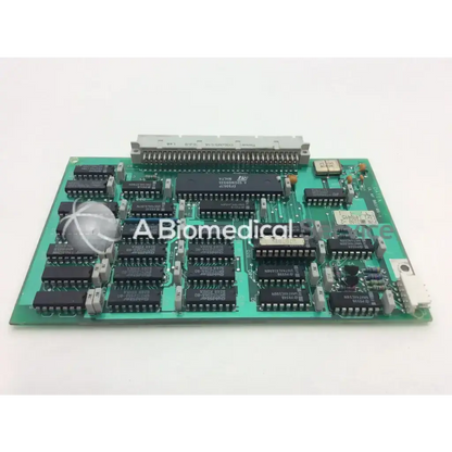 Green printed circuit board m74hcu04bi with black integrated circuits and gray connector datex ul 4f 883106-1 control board