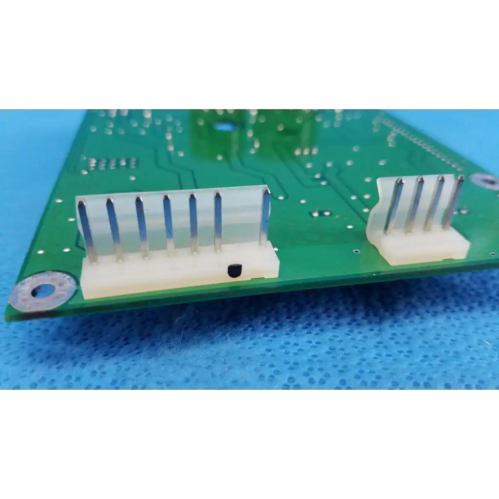 Green main power circuit board with two white plastic connectors and metallic pins for topcon retinal camera
