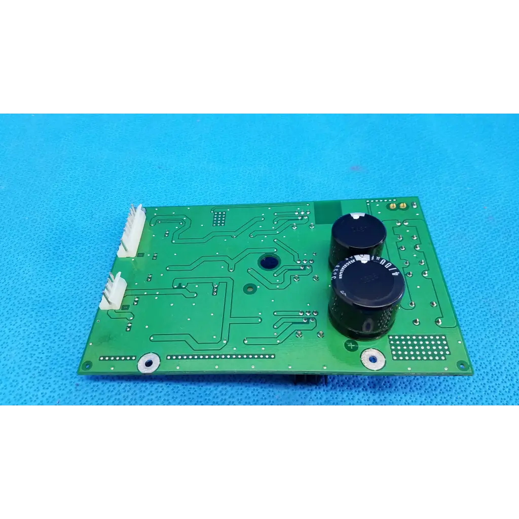 Green rectangular main power circuit board with black capacitors and white connectors for topcon retinal camera