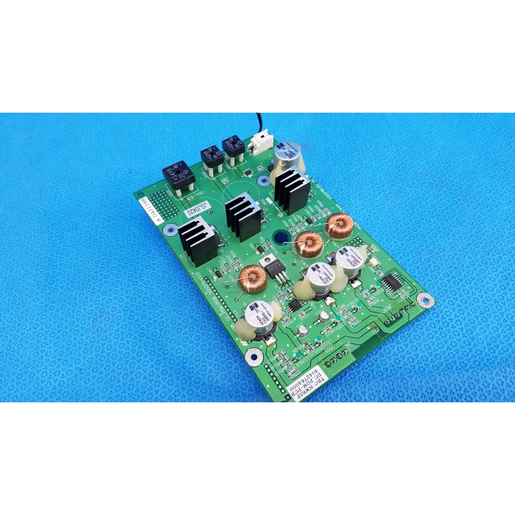 Green main power circuit board with black copper components white capacitors and heat sinks for Topcon retinal camera