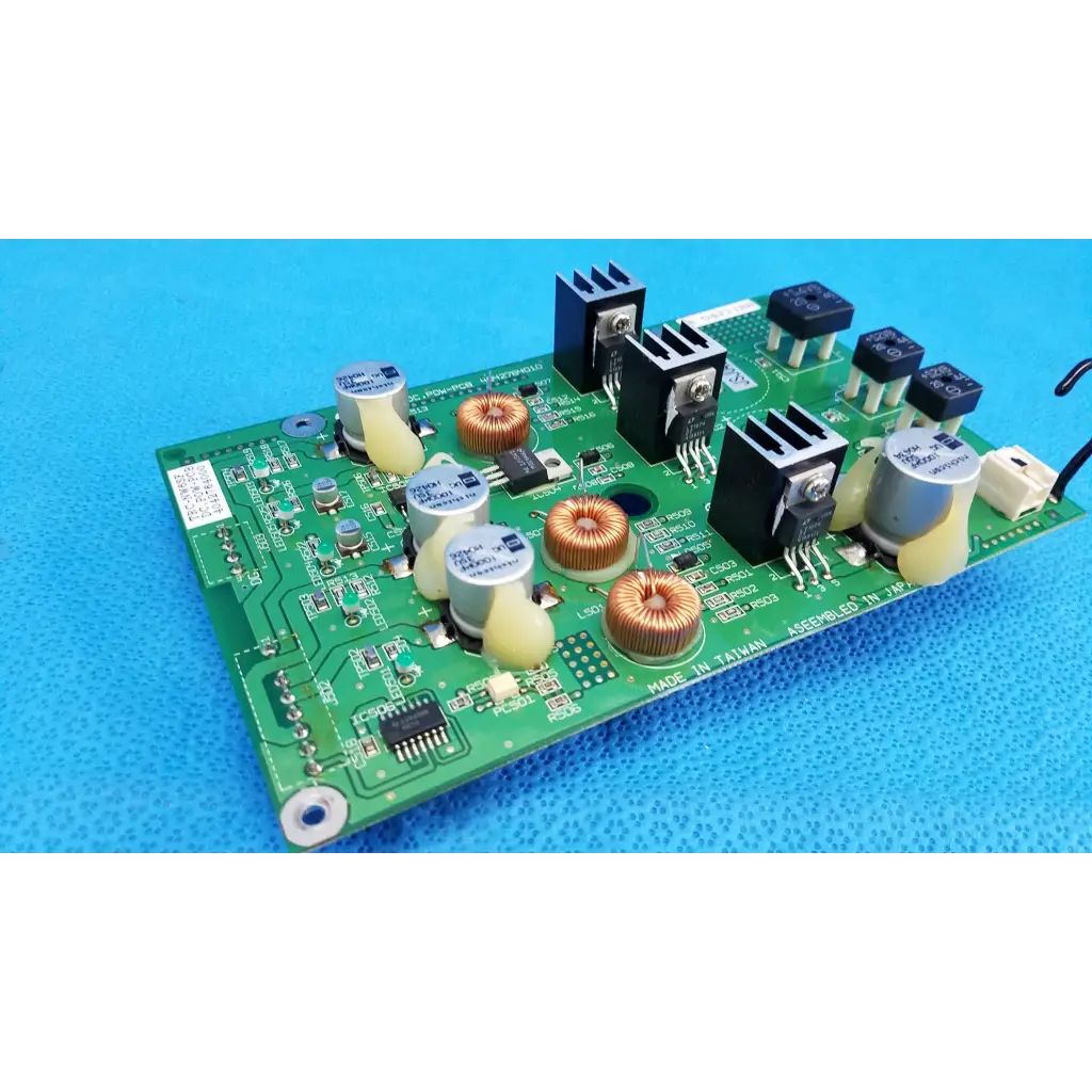 Green main power circuit board with black silver components copper coils capacitors and heat sinks for topcon retinal camera