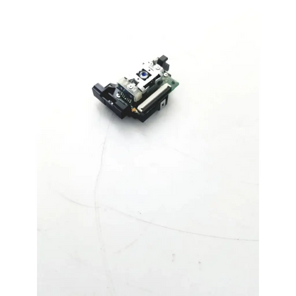Black and silver laser diode module with blue lens mounted on green circuit board of de470id8h 00e j49 board