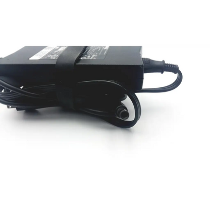 Black plastic dell da130pe1-00 laptop power charger with coiled power cord and label on top surface