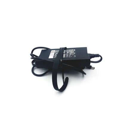 Black plastic dell la130pm121 ac adapter charger 130w with coiled cable and label on top surface